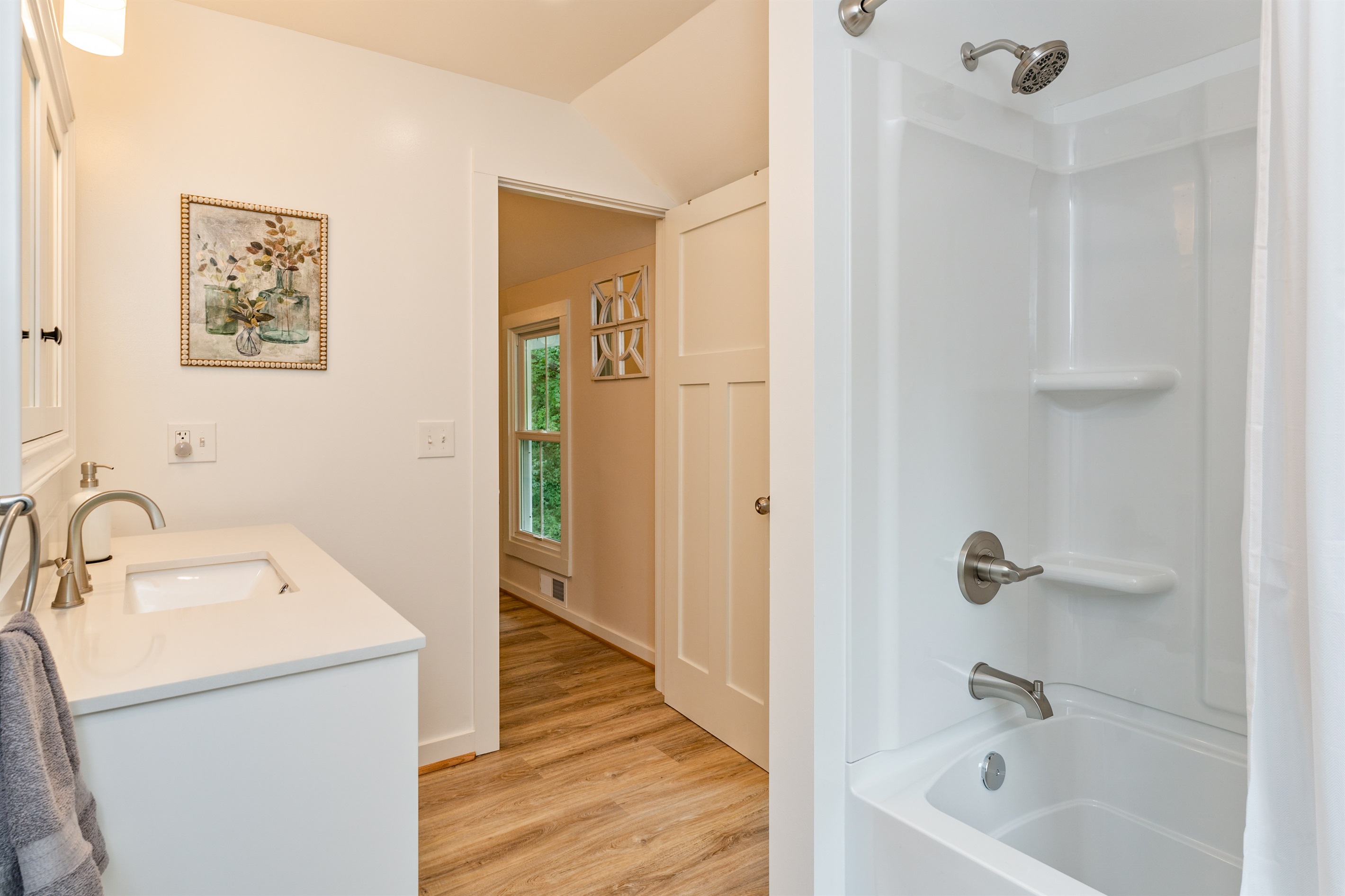 Crisp, clean design featuring a full shower/tub combo and spacious vanity for comfort and convenience.