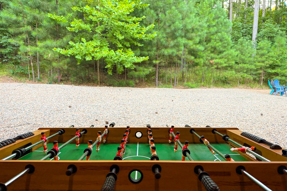 Foosball fun with a forest backdrop.