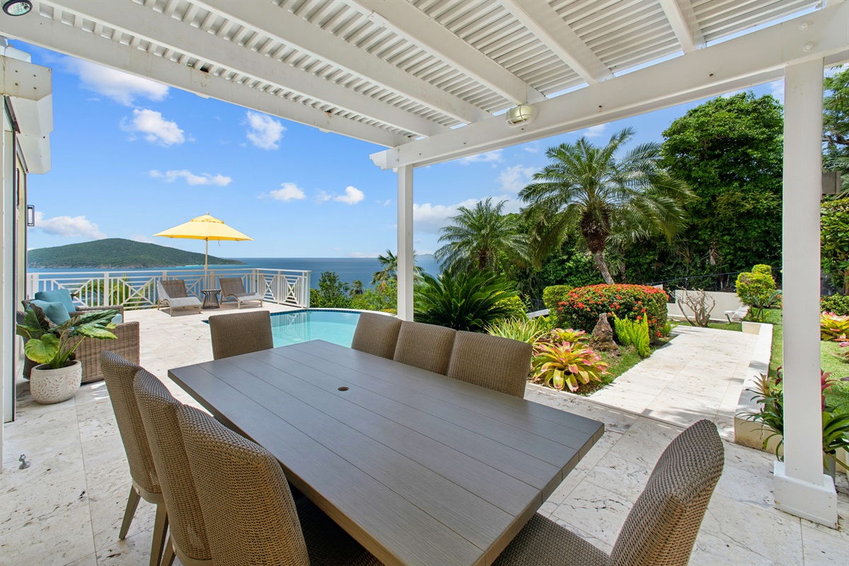 Covered patio with outdoor dining table and grill, perfect for sunset dinners or lazy brunches.