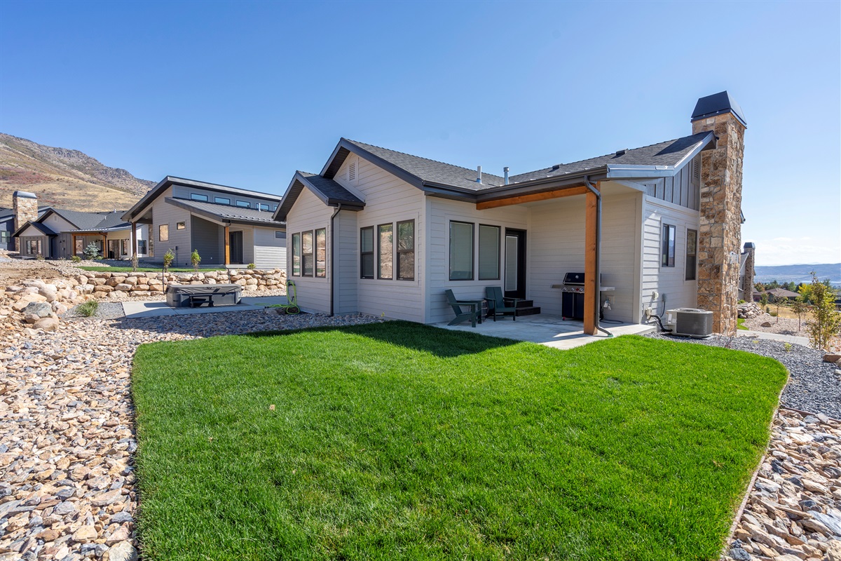 Modern exterior with private patio and beautifully landscaped surroundings.