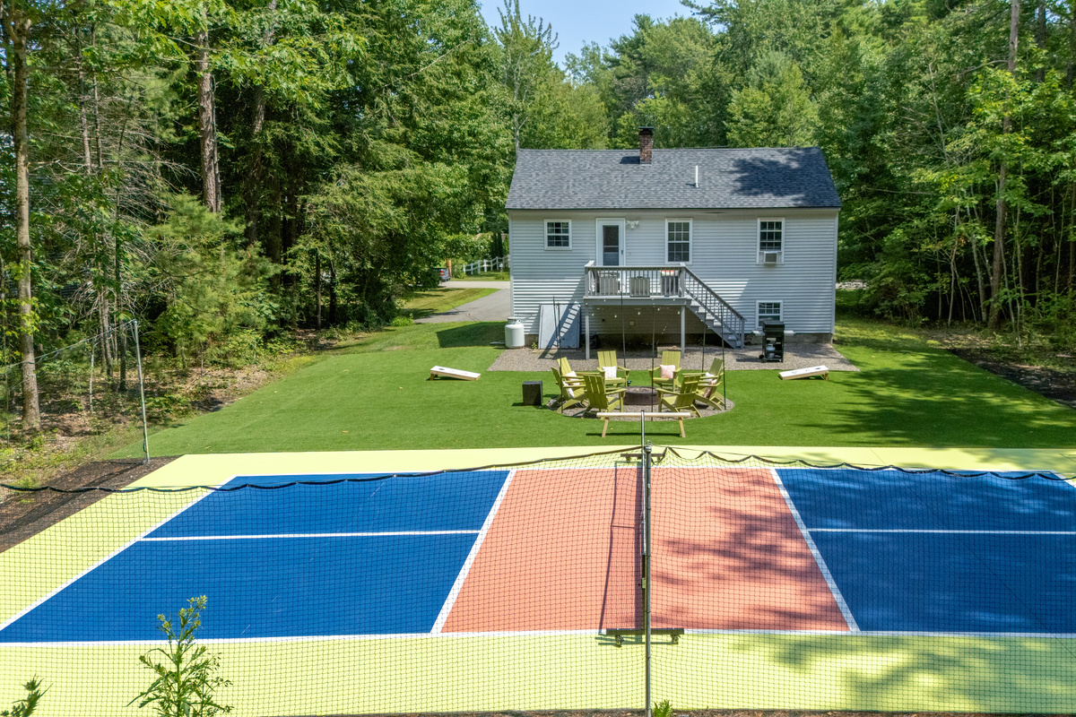 A breathtaking outdoor space with comfortable seating and a pickleball court, perfect for relaxing, gathering, and enjoying time together.