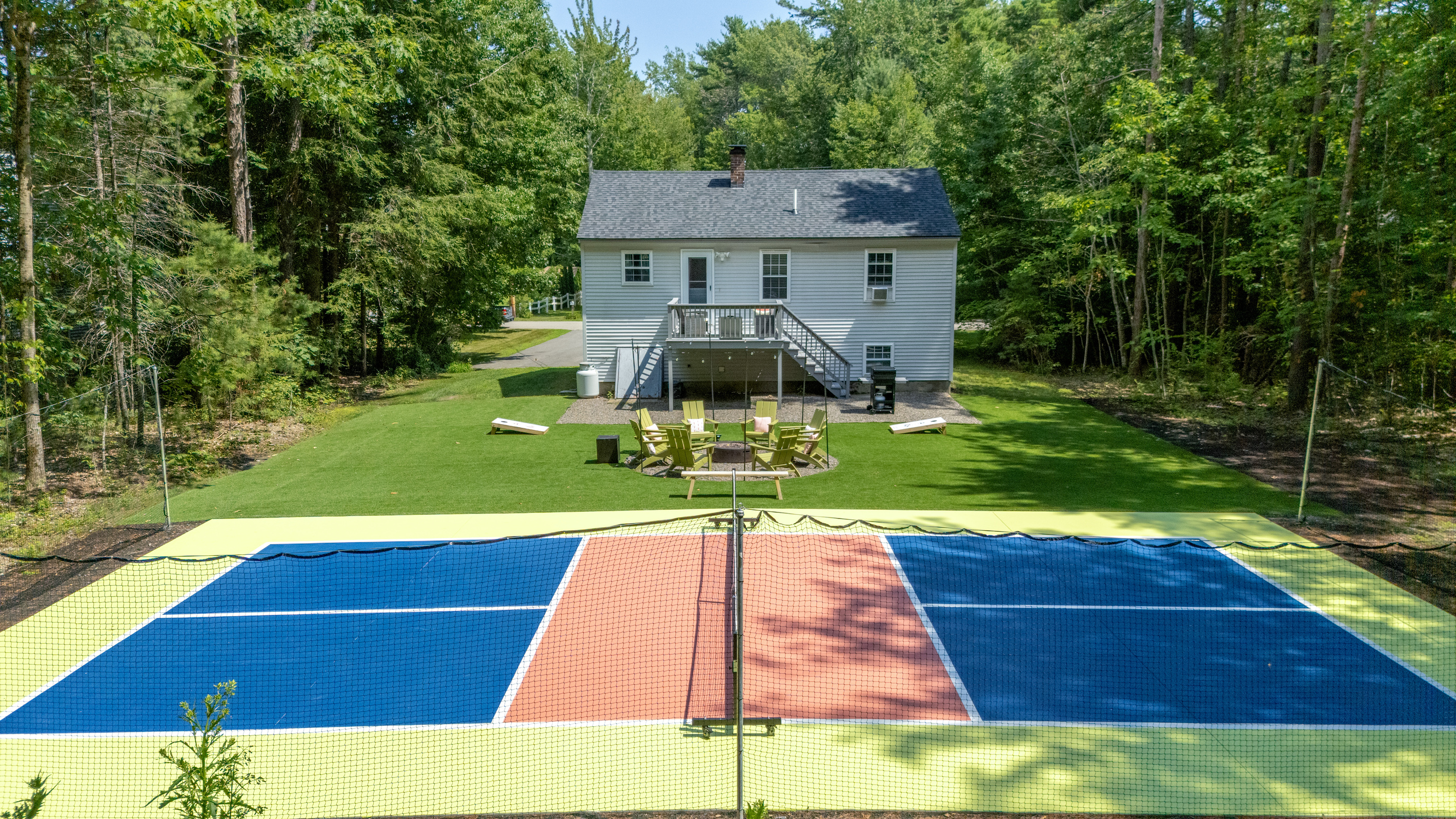 A breathtaking outdoor space with comfortable seating and a pickleball court, perfect for relaxing, gathering, and enjoying time together.