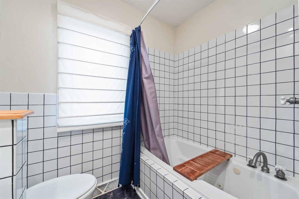 This bathroom is located on the main floor at the end of the hallway.