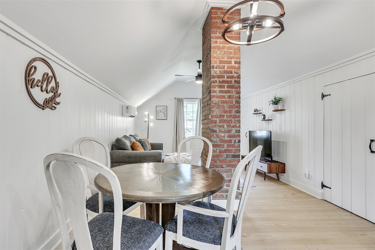 Enjoy meals surrounded by character—exposed brick details add a touch of historic charm to this intimate dining space.