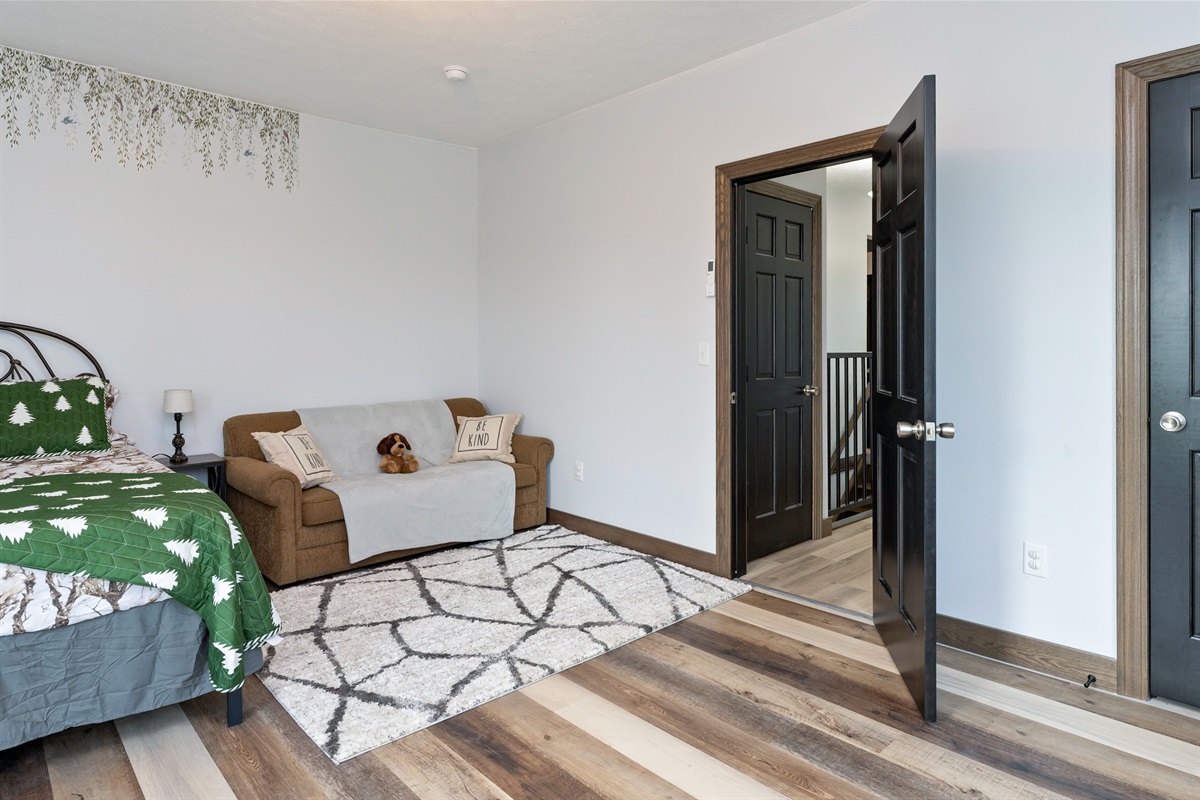 Inviting Queen bedroom with queen fold out sofa woodland-themed décor, and plenty of space to unwind. Bedroom #4