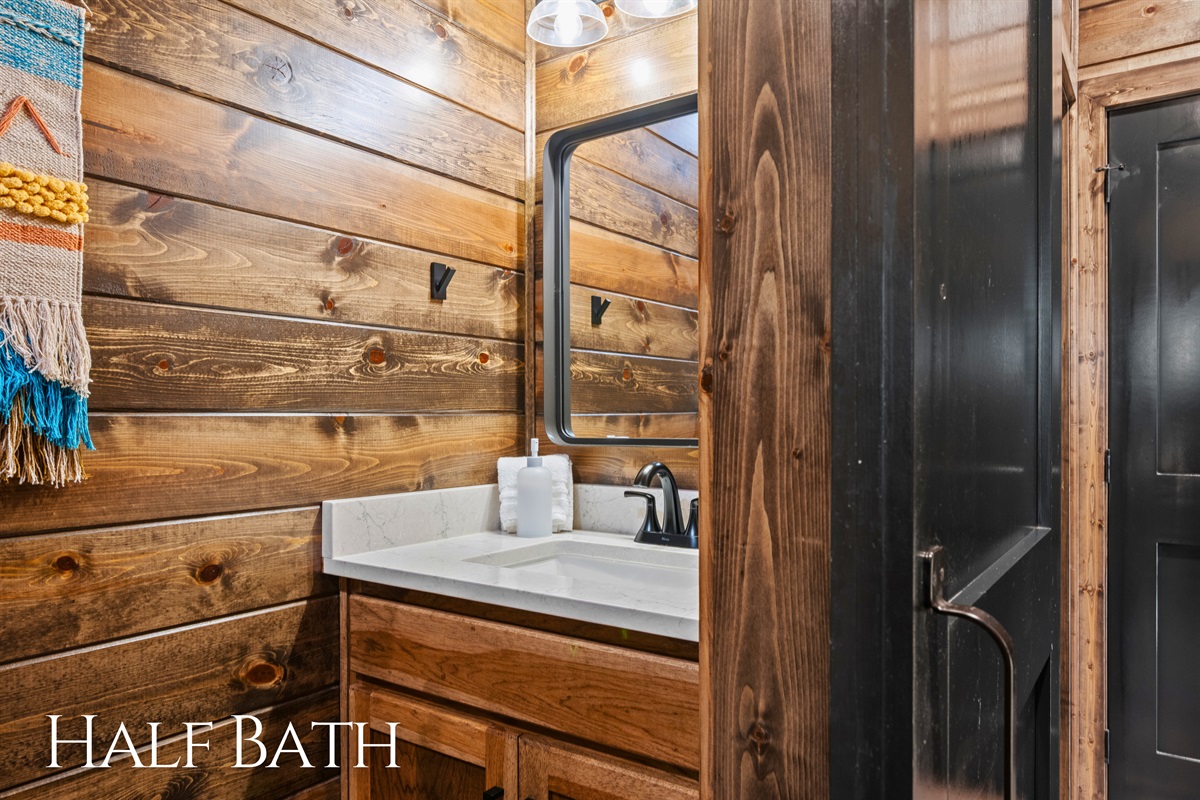 It’s always nice to have a half bath, and this one feels warm and welcoming with simple finishes that fit the cabin style perfectly.