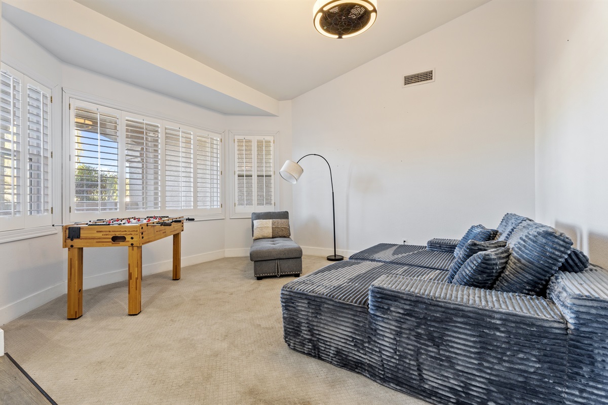 Whether you’re unwinding or playing foosball, this bonus room offers a cozy sectional, fun energy, and space to spread out.