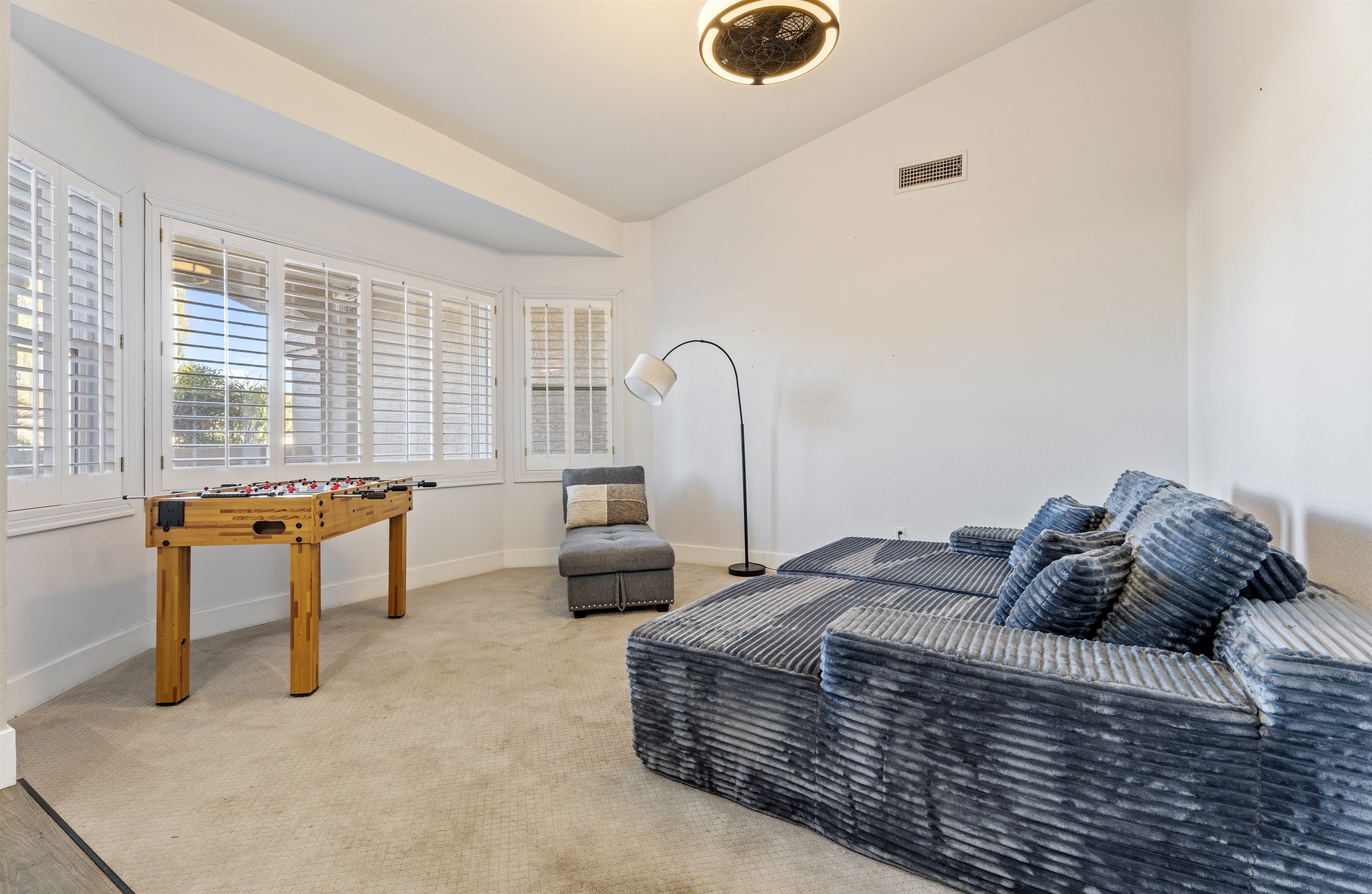 Whether you’re unwinding or playing foosball, this bonus room offers a cozy sectional, fun energy, and space to spread out.