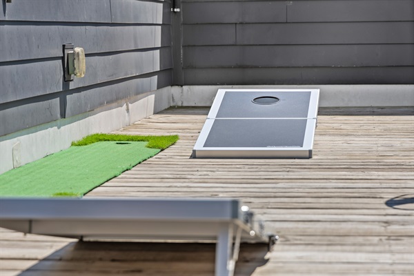 Outdoor Games Area: Enjoy lively cornhole games on the sunlit deck with friends and family!