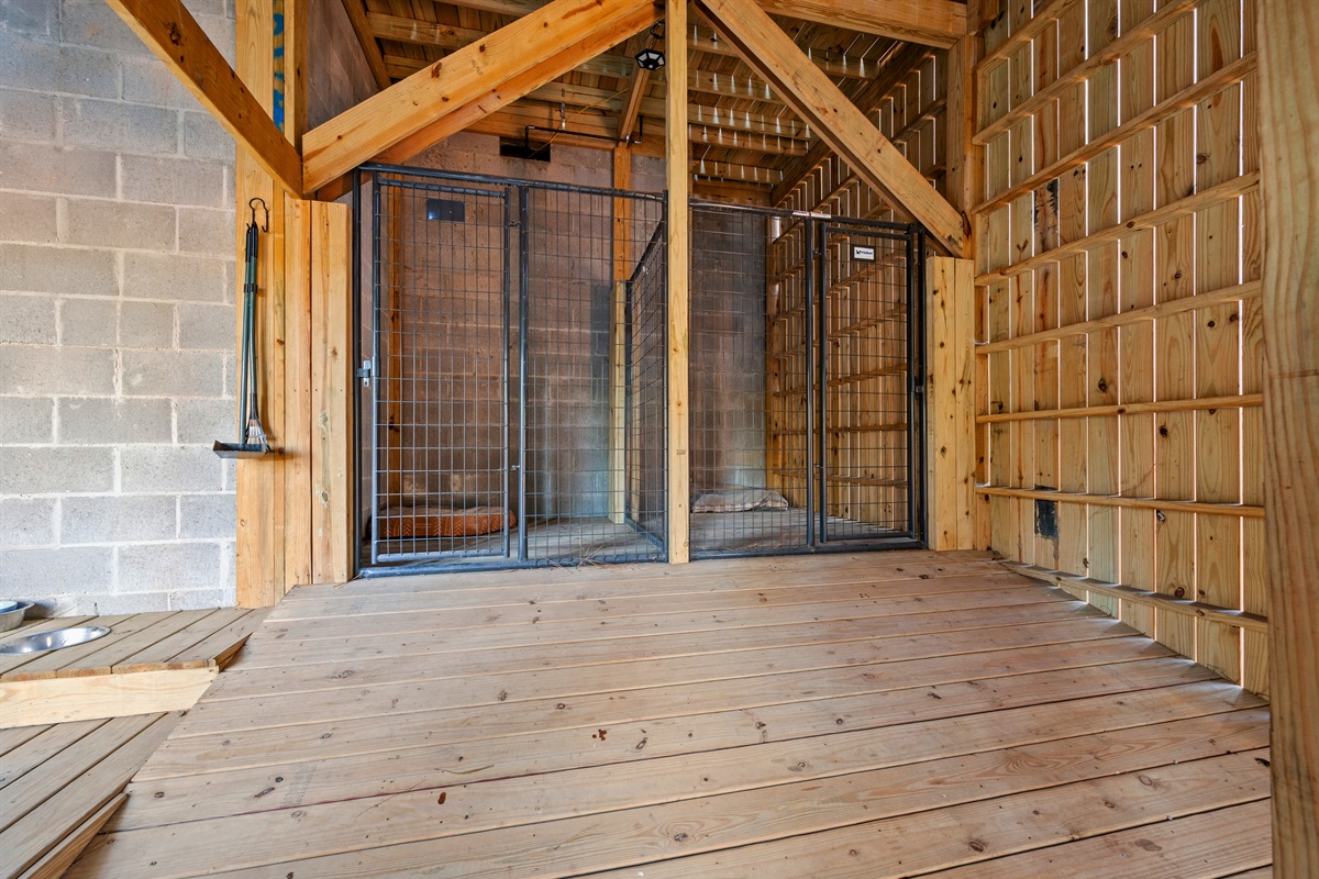 This kennel area feels spacious and sturdy, making it a great setup for guests traveling with dogs who want comfort and convenience.