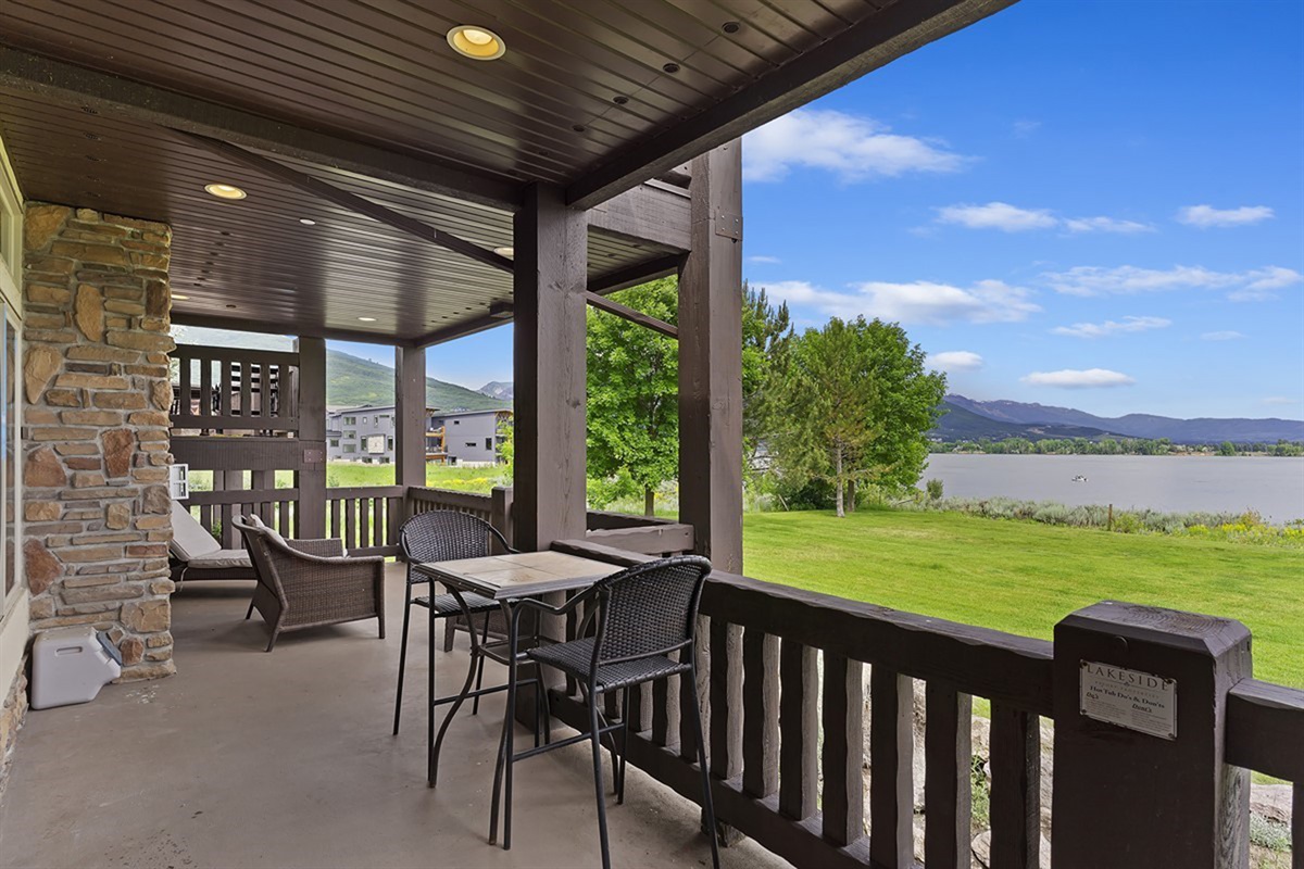 Covered patio with outdoor dining and sweeping views of Pineview Reservoir.