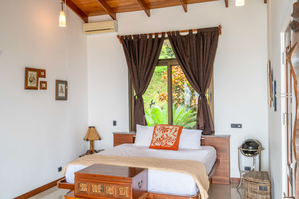 King bedroom suite with rich wood cabinetry and garden terrace access