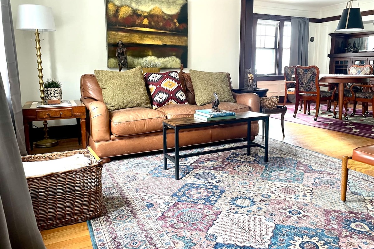 A welcoming living space with plush seating, curated décor, and natural light—designed for slow mornings, cozy evenings, and easy connection to the dining area.