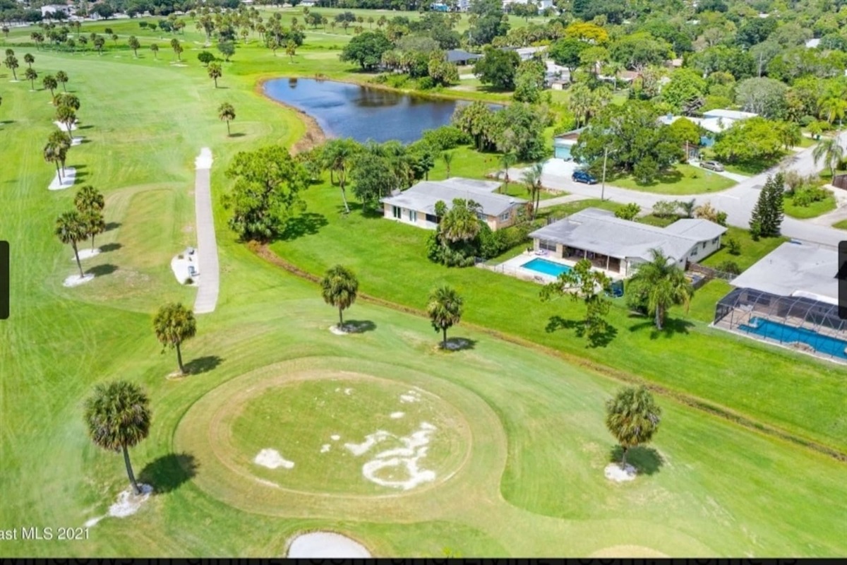 PHOTO OF ACTUAL HOME currently under renovation. Pool Home to the right of the green.