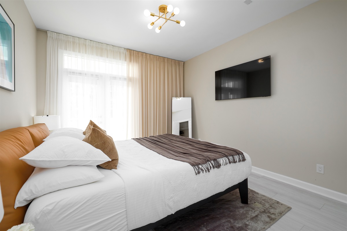 Bedroom 2 (1st Floor): KING bed, Patio Access, Smart TV, Bathroom with Remodeled Walk-in Shower in Hallway - shared with Bedroom 2 (Sleeps 2)