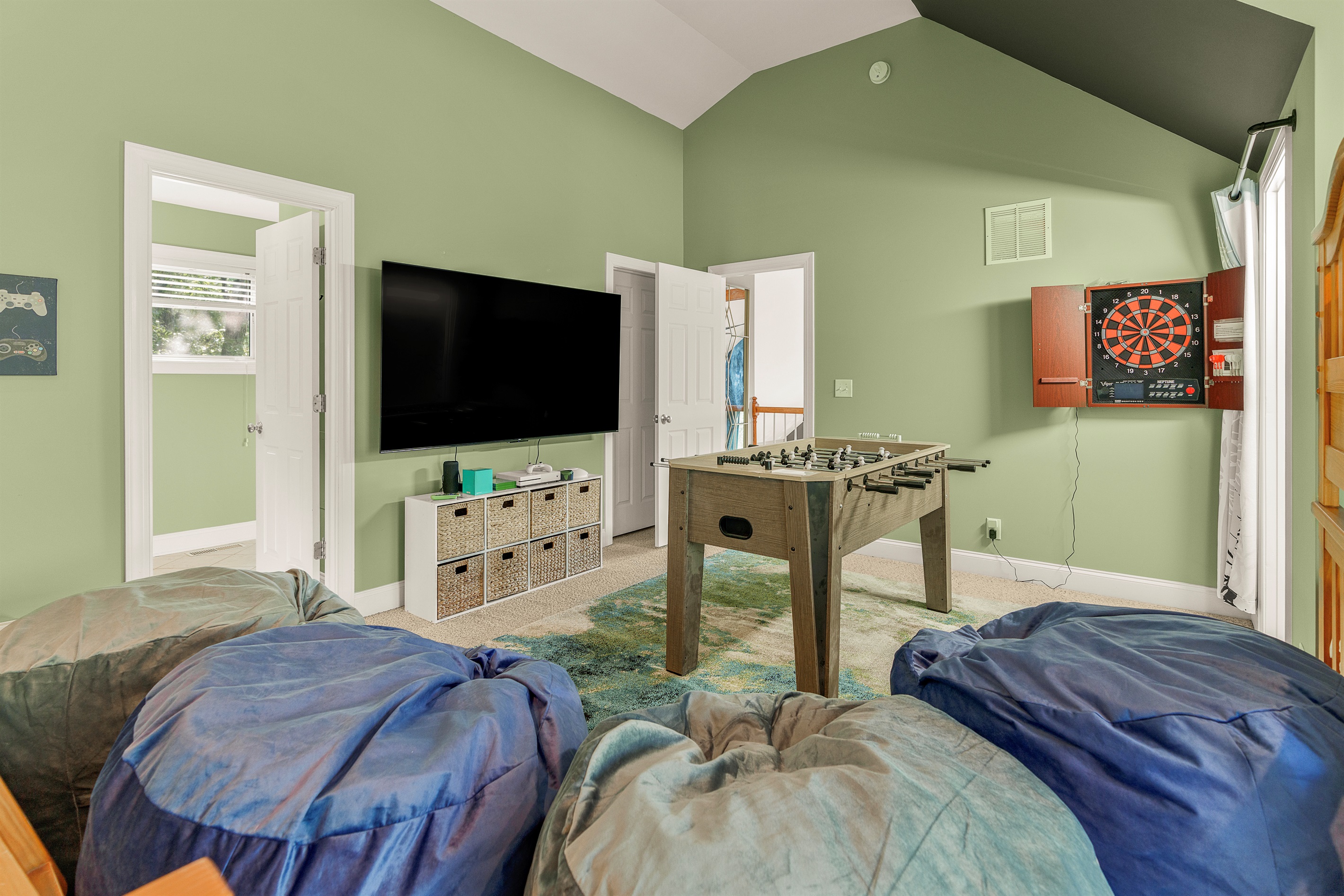 75" TV, foosball, and oversized beanbags make this bunkroom a true game zone. Fun enough for kids, chill enough for teens or adults
