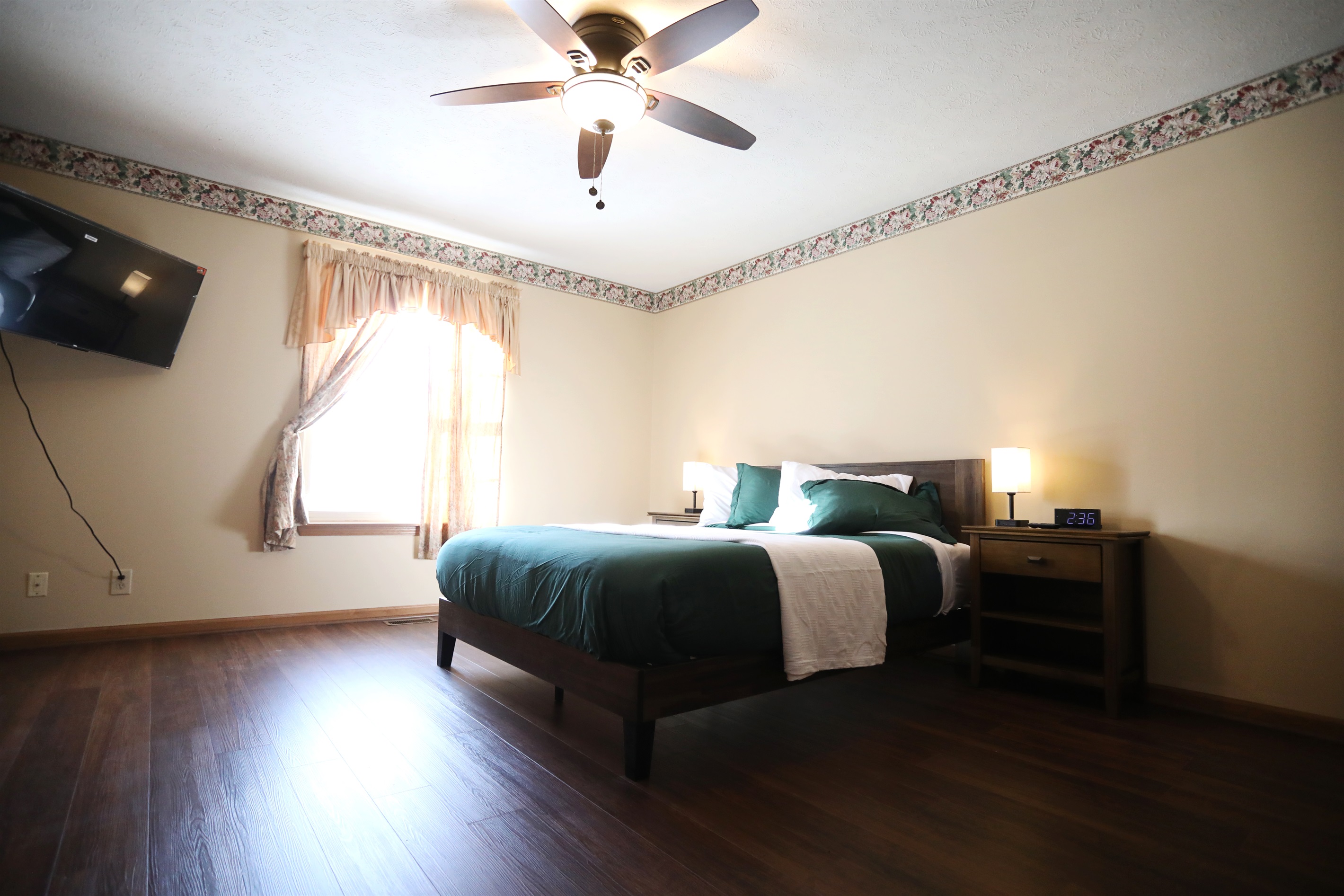 Master Suite showing Roku TV, dresser, queen size bed, nightstands with touch lamps and alarm clock