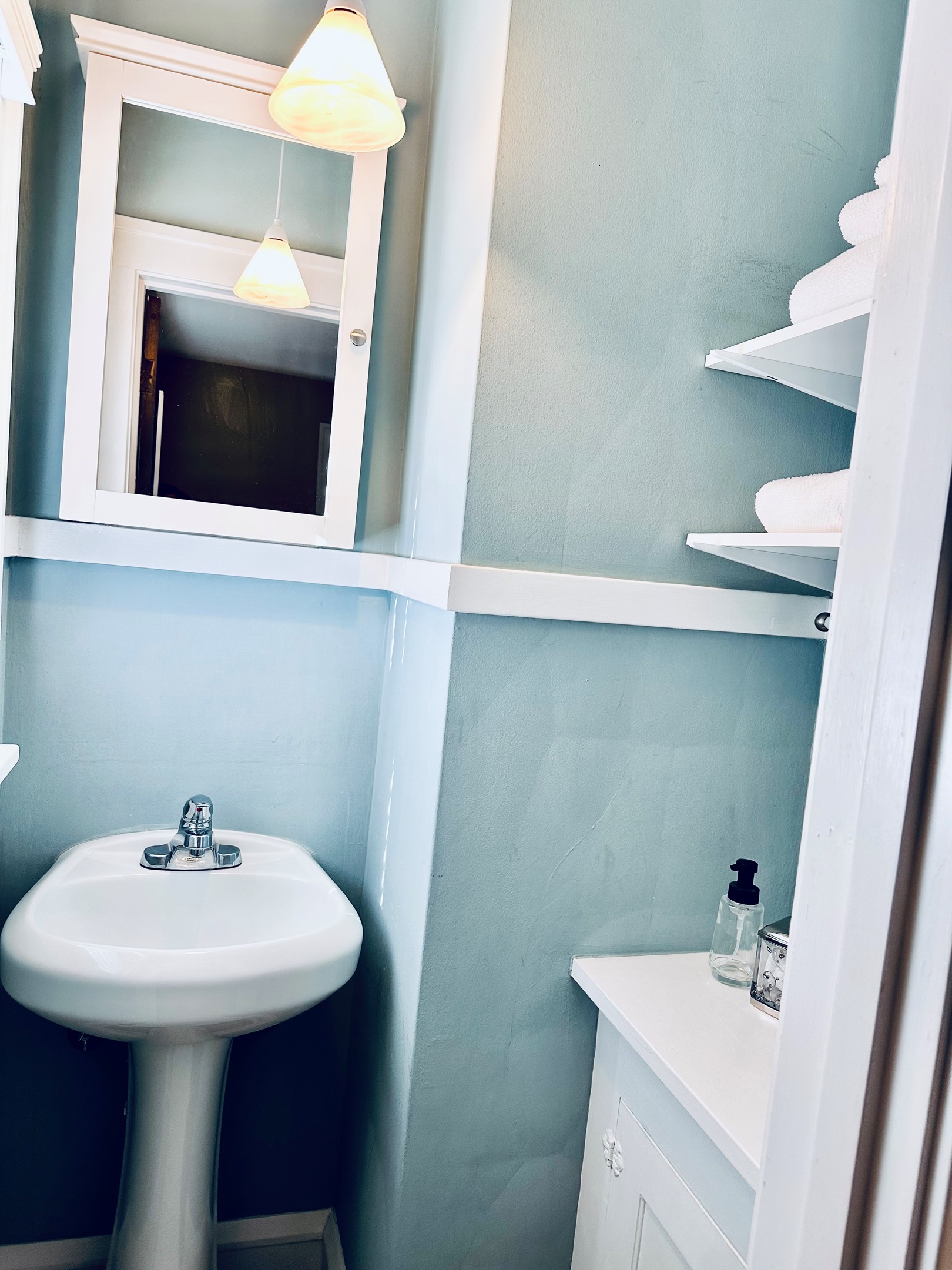 Bedroom #1:  This primary room includes a closet equipped with a sink, countertop with an electrical outlet and a medicine cabinet.  While not quite a half bath, it does provide for a private dressing area away from the main bath.