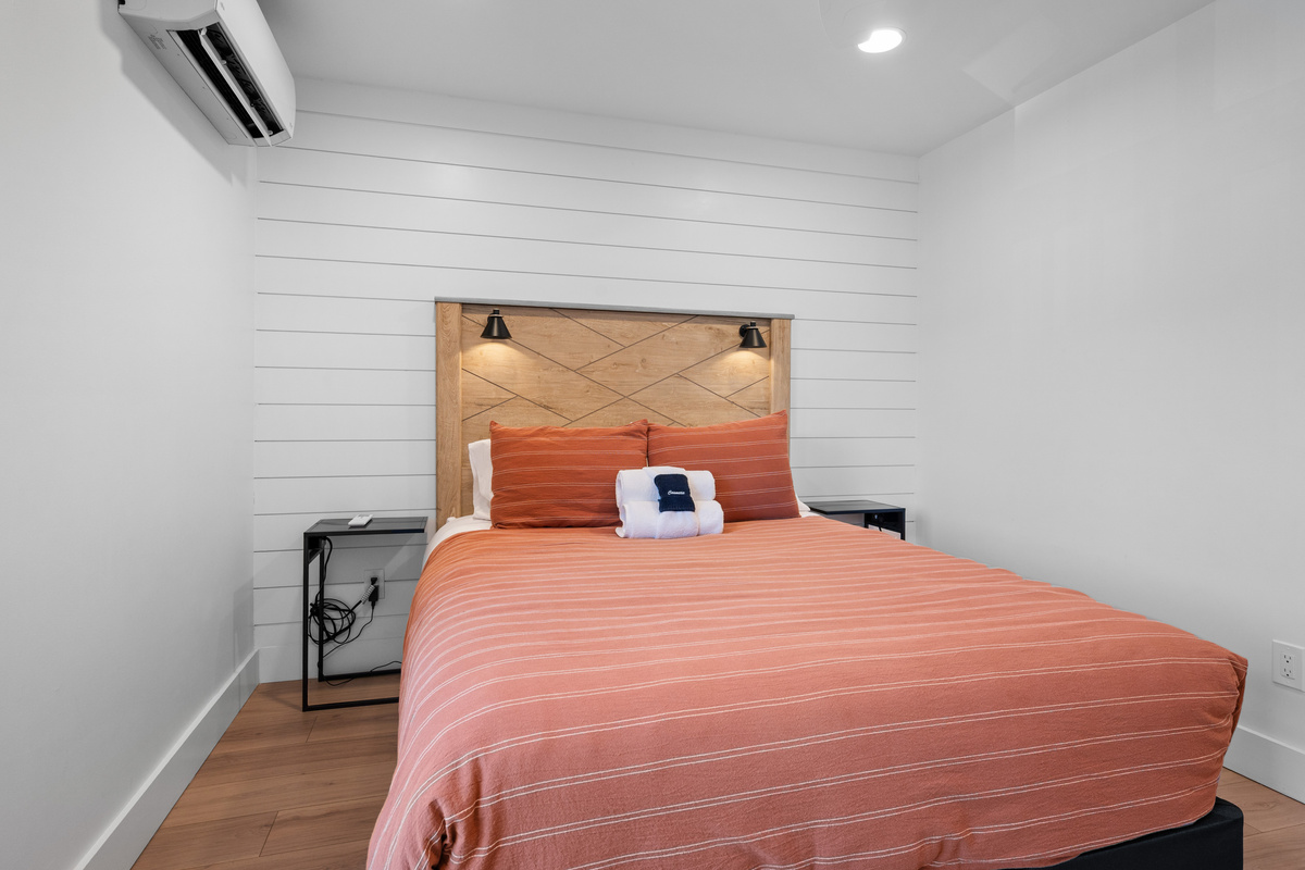 Relaxing guest bedroom with a Queen bed, modern furnishings, and mountain-inspired décor.