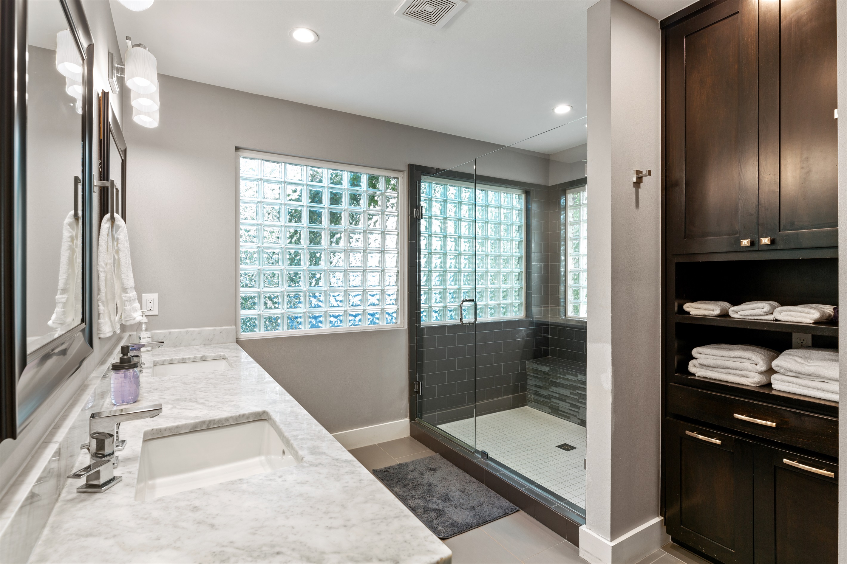 Master Bathroom with Walk in shower, separate room and door for toilet, and two sinks.