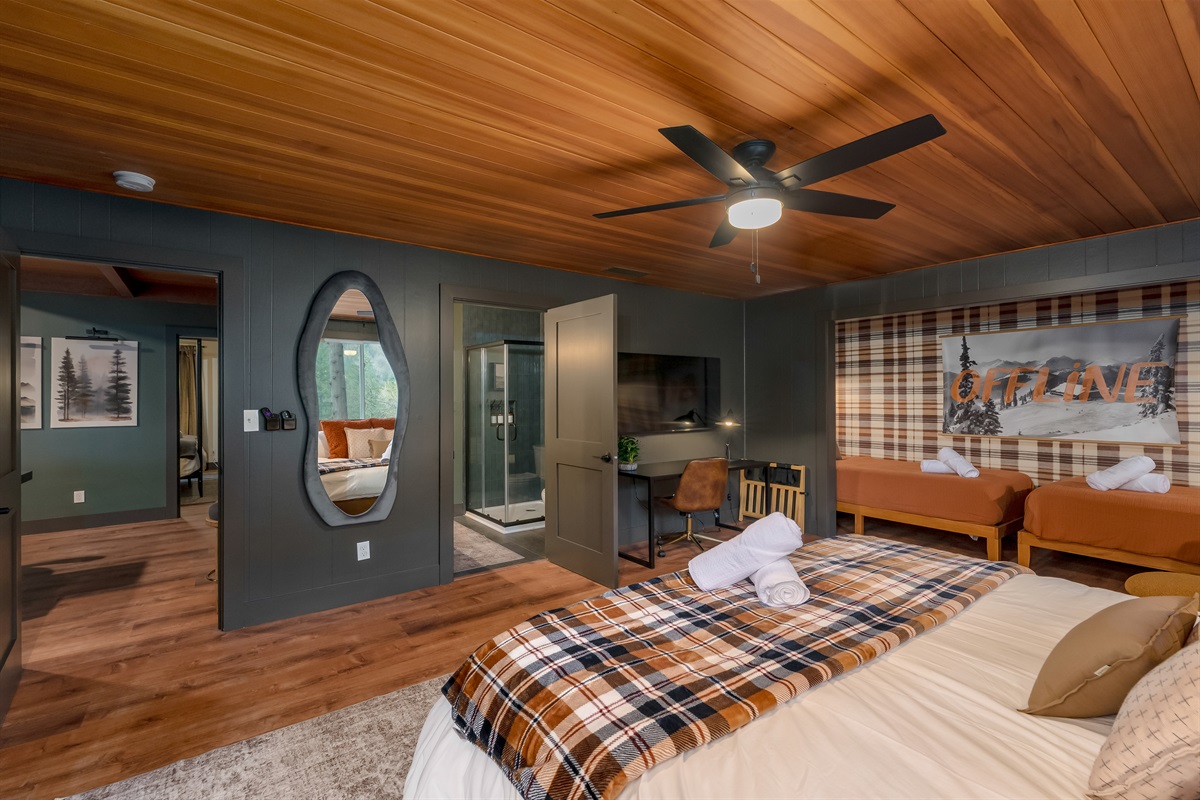 Spacious ensuite king suite with its own twin alcove, dedicated workspace, and private bathroom—designed for comfort, flexibility, and retreat-style relaxation.