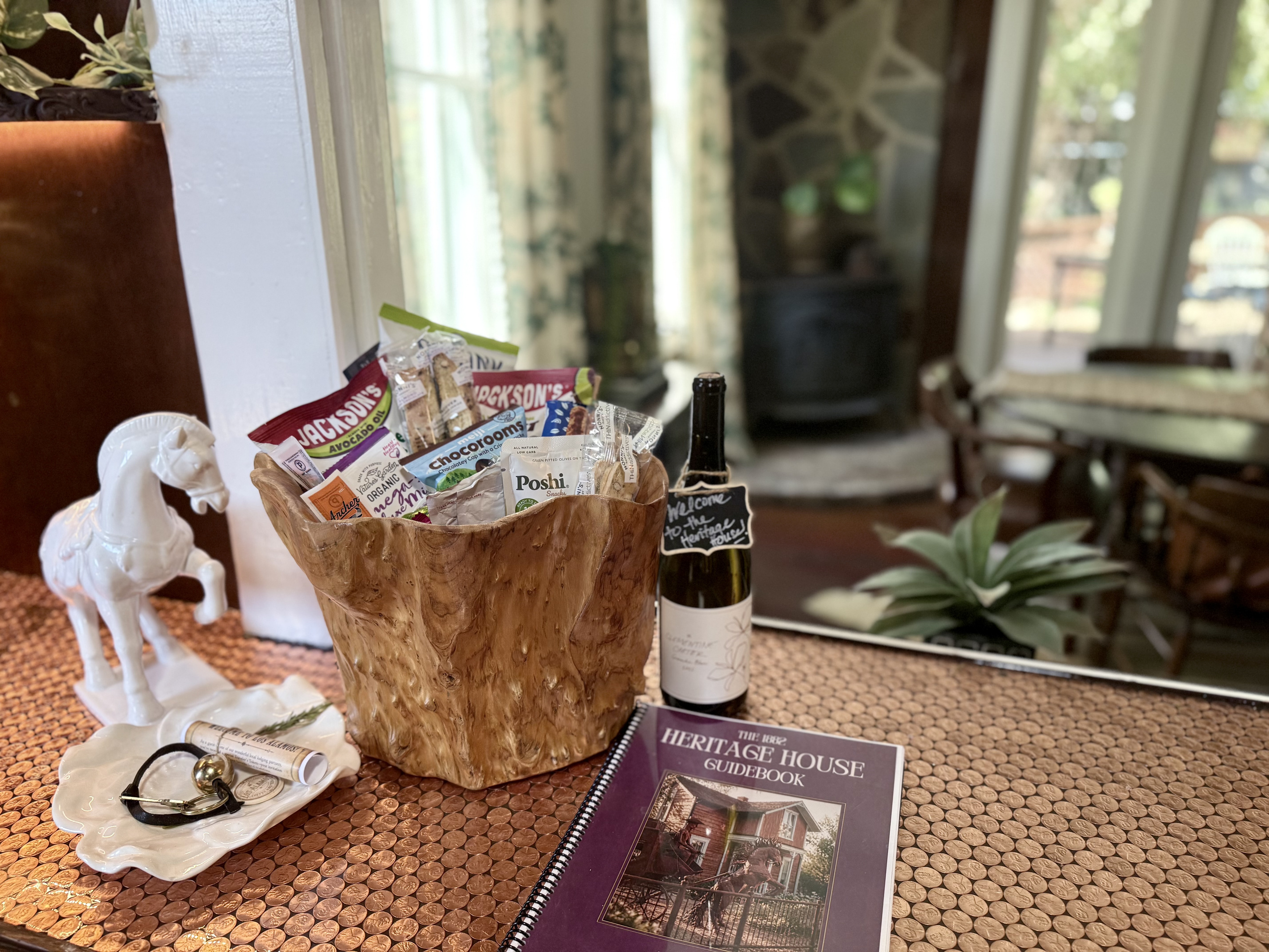 Your Welcome Basket is waiting: locally made wine, olives and a few thoughtful treats, arranged at the illuminated pass-through "penny for your thoughts" bar between the kitchen and dining room. Pour a glass, unpack later and let the getaway begin.