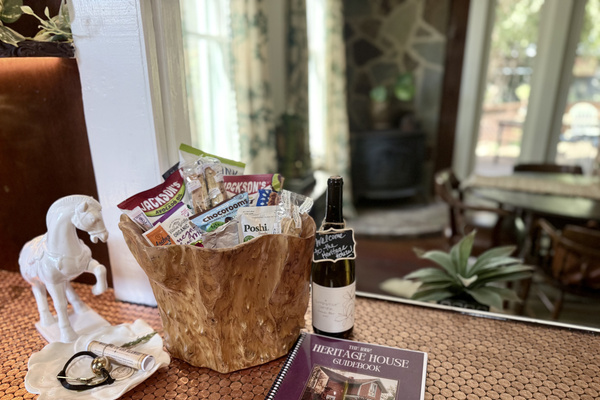 Your Welcome Basket is waiting: locally made wine, olives and a few thoughtful treats, arranged at the illuminated pass-through "penny for your thoughts" bar between the kitchen and dining room. Pour a glass, unpack later and let the getaway begin.