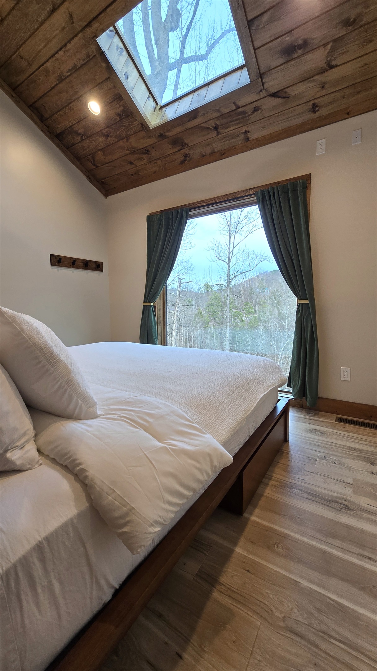 The bedroom features a giant 7' window and skylight window.