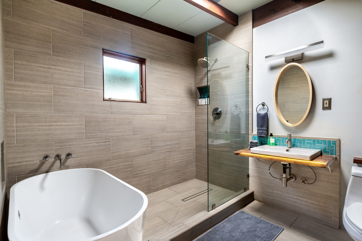 Completely renovated bathroom with deep tub and rain shower. 