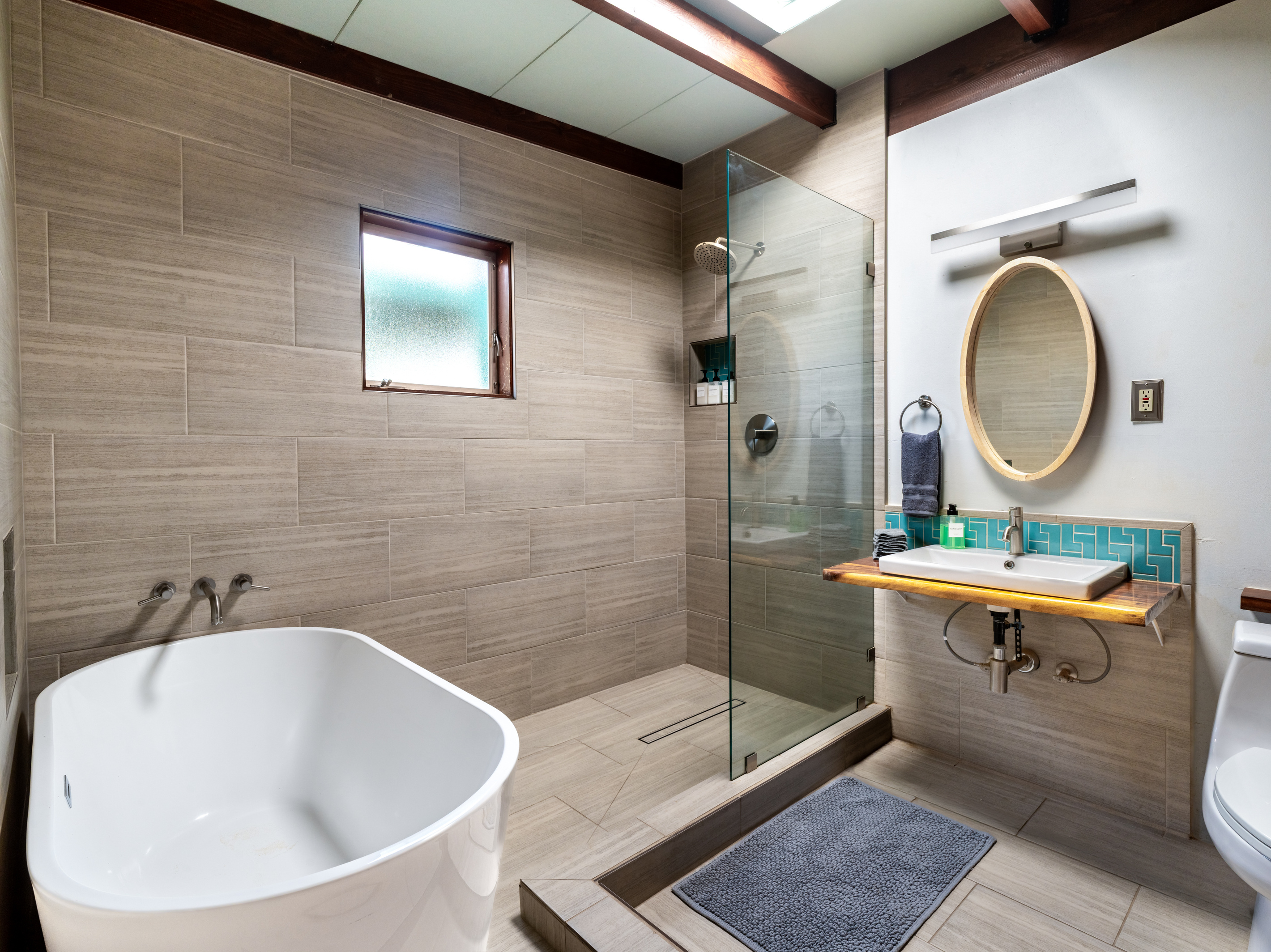 Completely renovated bathroom with deep tub and rain shower. 