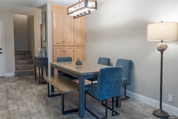 The dining room table has seating for six, and the storage cabinets are loaded with games.