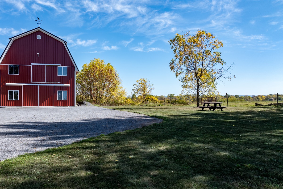 Red barn set against open skies — an iconic upstate New York backdrop for your stay
