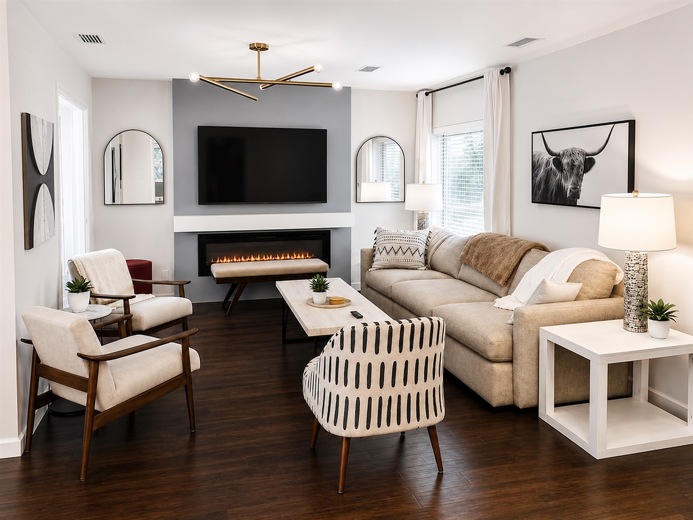 Stylish main living room with cozy fireplace, oversized smart TV, and thoughtfully curated designer furnishings