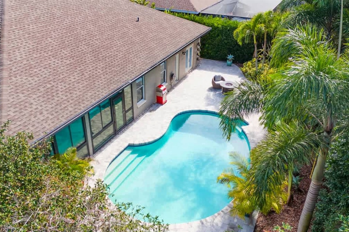 Overhead pool view showing a sunny, private retreat.