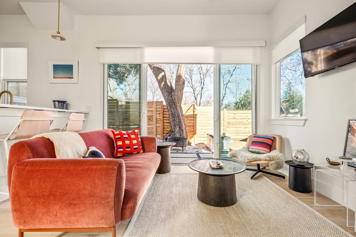 Comfortable living room with stylish seating and access to the private courtyard