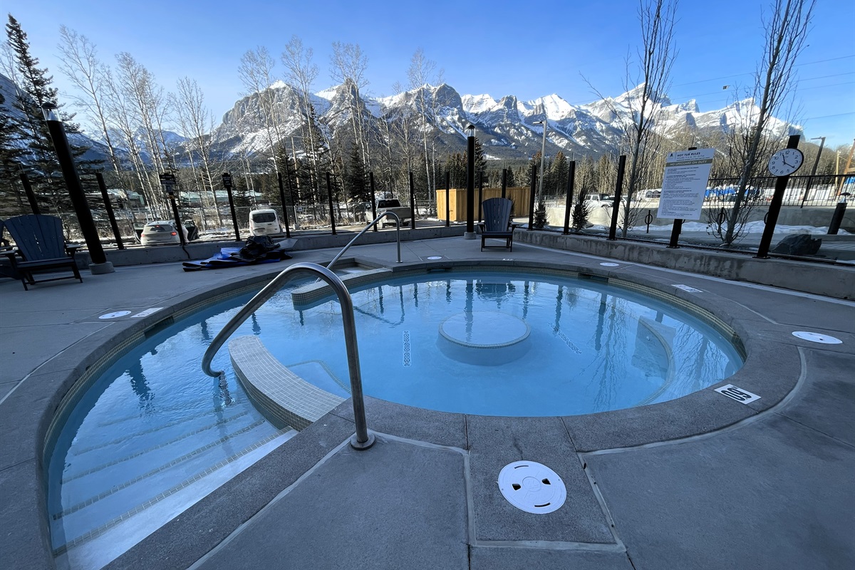 Hot tub with a gentle entry, mountain view, and adjacent pool. Unforgettable mountain view.
