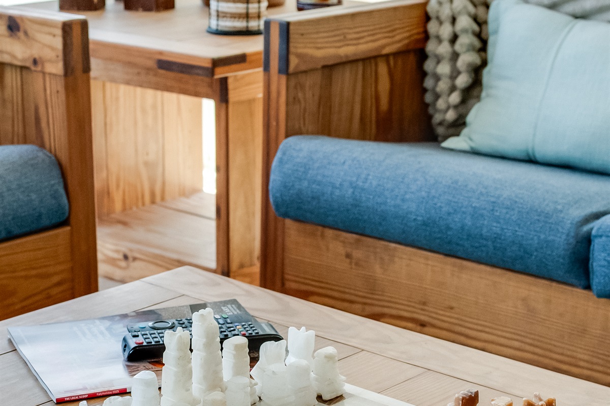 Living Room: Enjoy games and laughter over a unique chess set in a sunlit, stylish space!