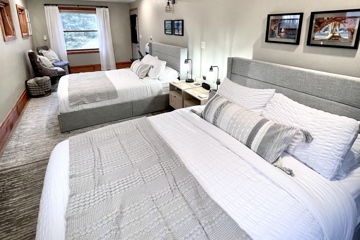 2 Queen main bedroom , located on the  lower entry level. Enjoy the electric fireplace and seating area surrounded by 7 windows and plenty of light    *note this is main lower entry level must take stairs to access upper loft kitchen living bathroom*