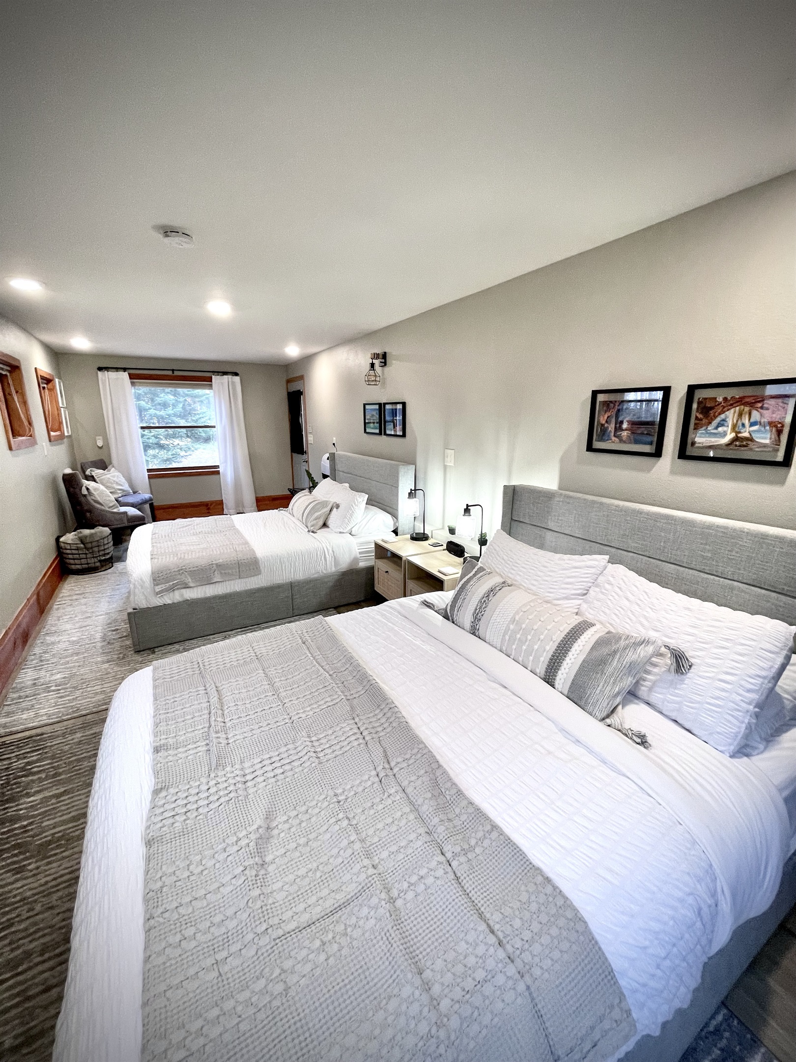 2 Queen main bedroom , located on the  lower entry level. Enjoy the electric fireplace and seating area surrounded by 7 windows and plenty of light    *note this is main lower entry level must take stairs to access upper loft kitchen living bathroom*