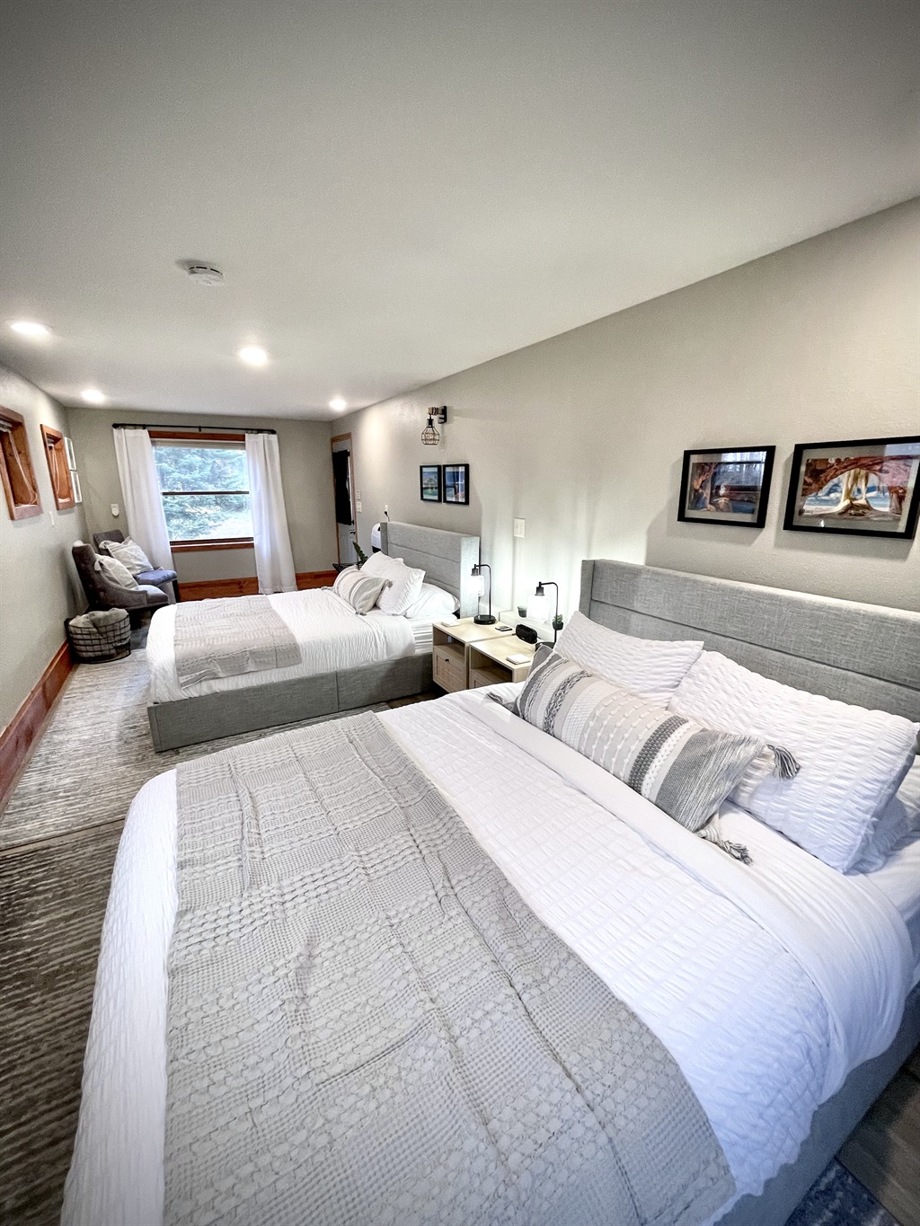 2 Queen main bedroom , located on the  lower entry level. Enjoy the electric fireplace and seating area surrounded by 7 windows and plenty of light    *note this is main lower entry level must take stairs to access upper loft kitchen living bathroom*