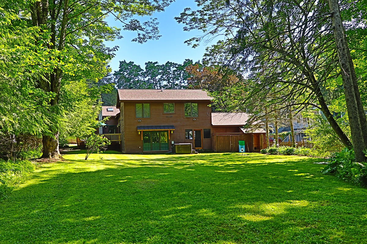 Rear elevation and view of the large backyard.