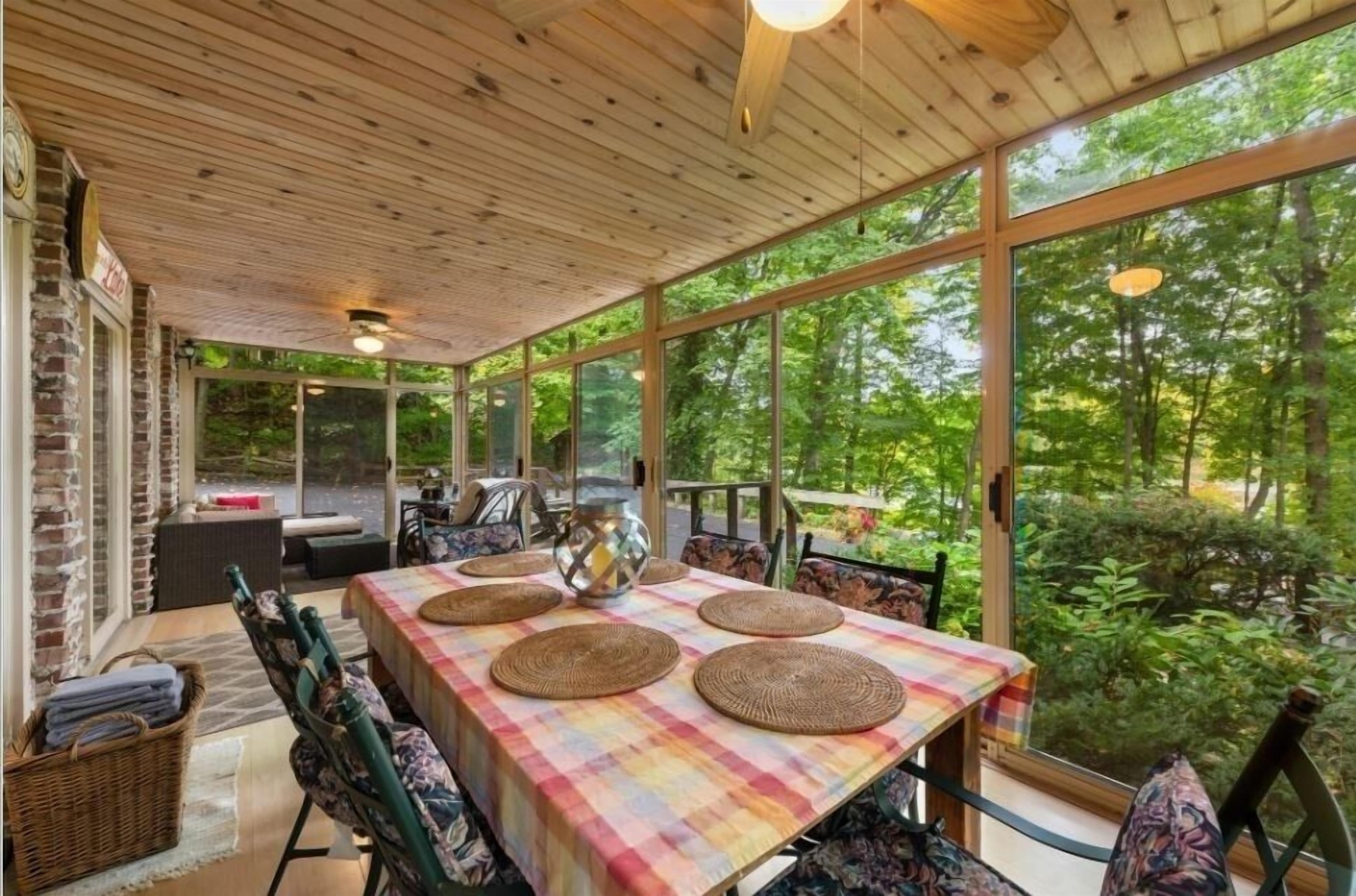 3 season room eating area- with sofa and comfy chairs facing the lake