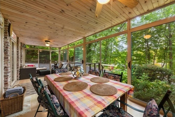 3 season room eating area- with sofa and comfy chairs facing the lake