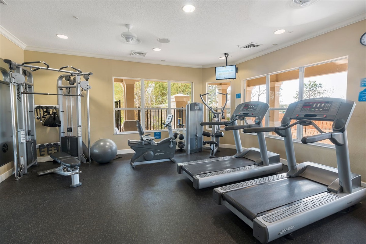 Fitness center with treadmills, machines, and free weights.


