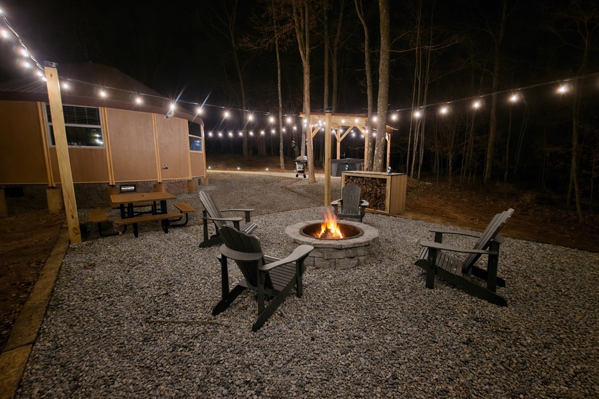 End the day gathered around the glowing fire pit, surrounded by café lights and towering trees—an inviting outdoor space perfect for romantic conversations, stargazing, and quiet evenings toge