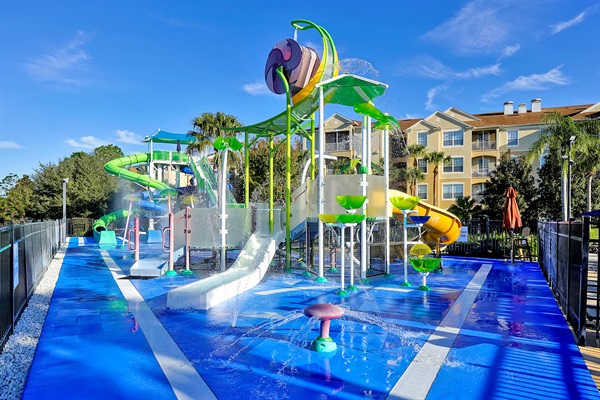 Expansive splash pad and play area with slides, fountains, and excitement for all ages