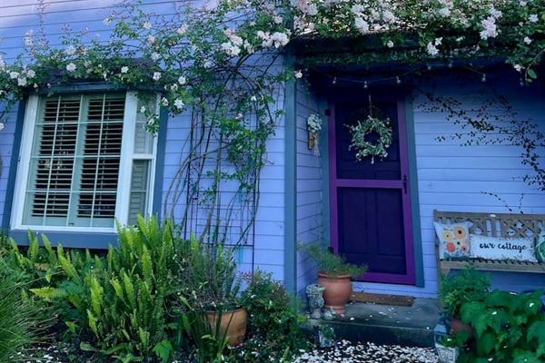 Charming front yard with a peaceful fountain and roses that bloom beautifully in April and May.