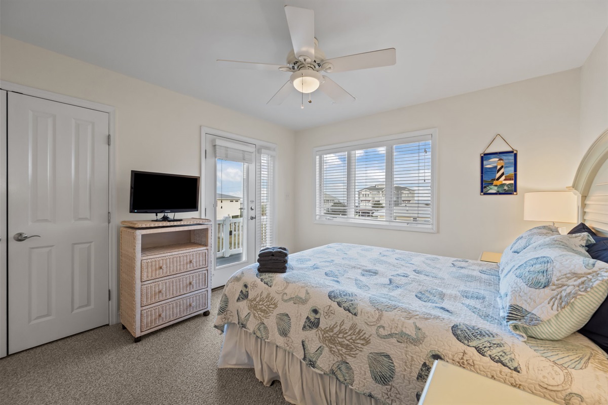 2nd floor bedroom with TV and private balcony access