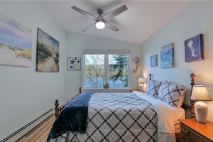 "the coast" room featuring a queen bed and an amazing view