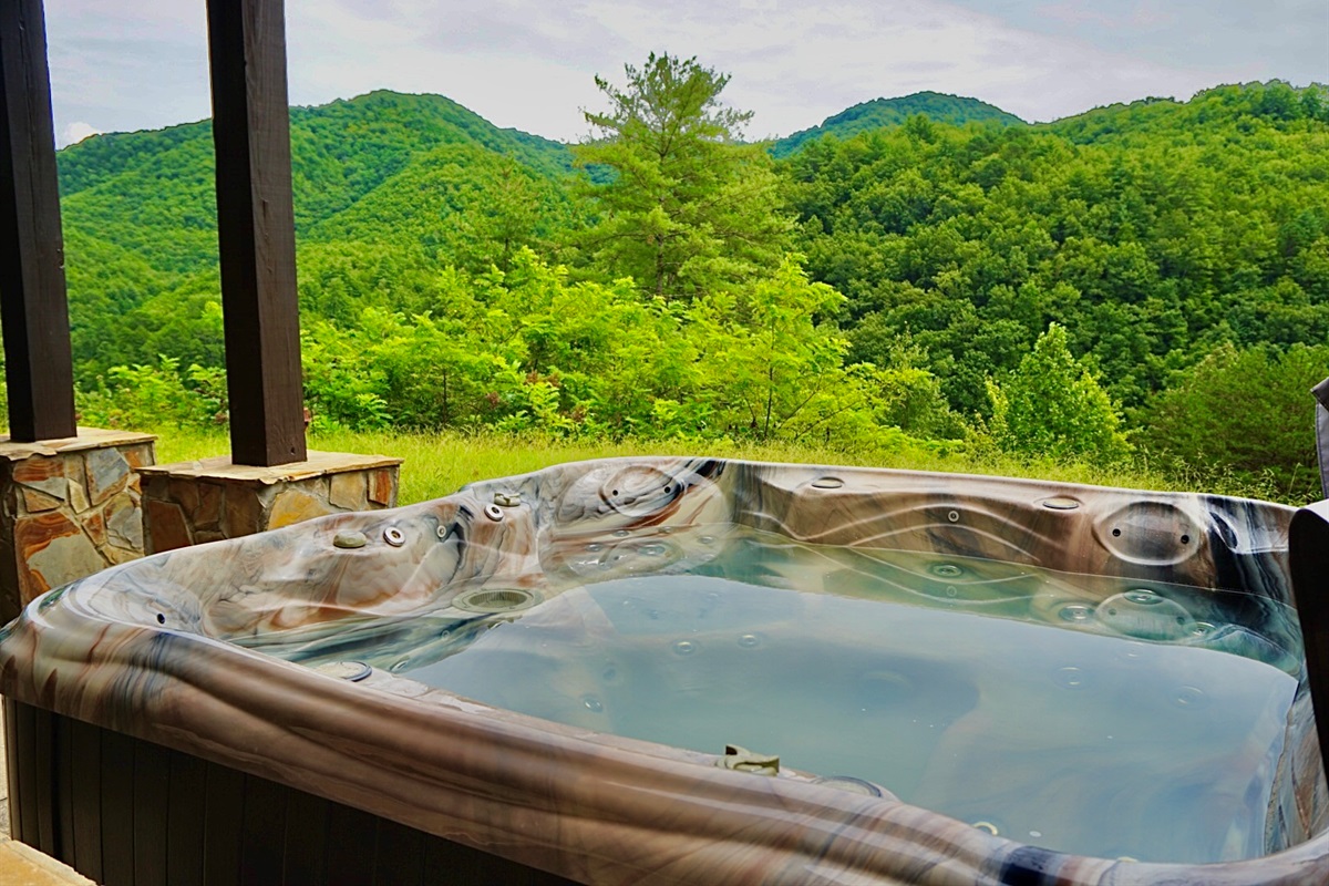 Outdoor Retreat: Soak in the hot tub with stunning mountain views—your perfect nature escape!